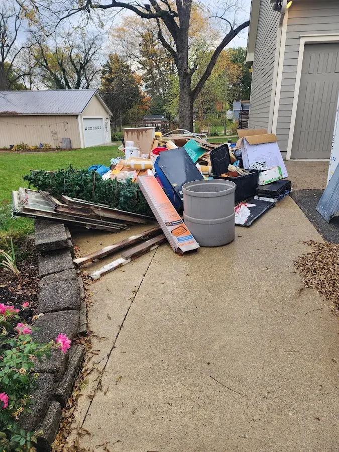 Dumpster being loaded with debris for Estate Cleanout Dumpster Rental in Hillside